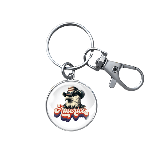 "Stainless steel keychain featuring bald eagle in cowboy hat with retro 'America' text"