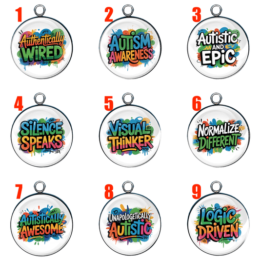 A collection of round handmade glass cabochon charms in various sizes and colors, each with autism pride phrases such as “Autistic and Epic,” “Visual Thinker,” “Silence Speaks,” and “Normalize Different.” Silver and gold bases shown.