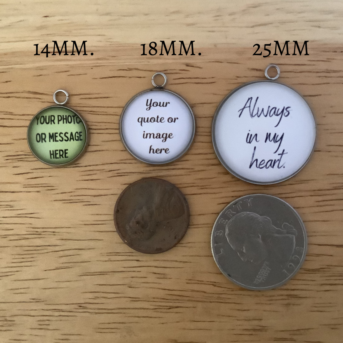 Three round pendants of different sizes on a wooden surface with text and coin for scale.