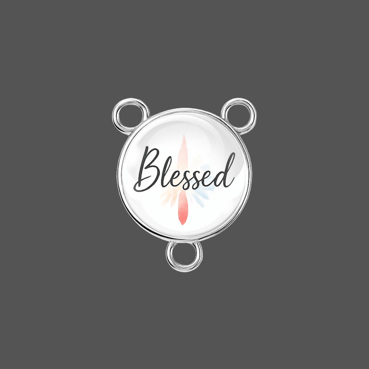 Round silver charm with 'Blessed' text and feather design on a dark gray background