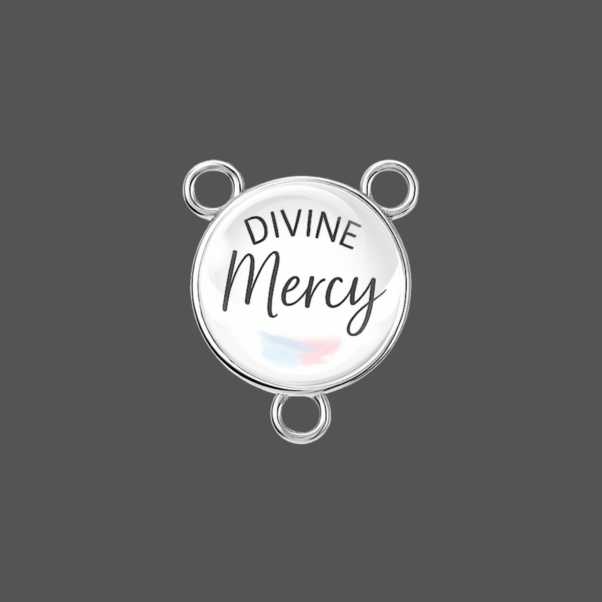 Round silver pendant with 'Divine Mercy' text on a gray background