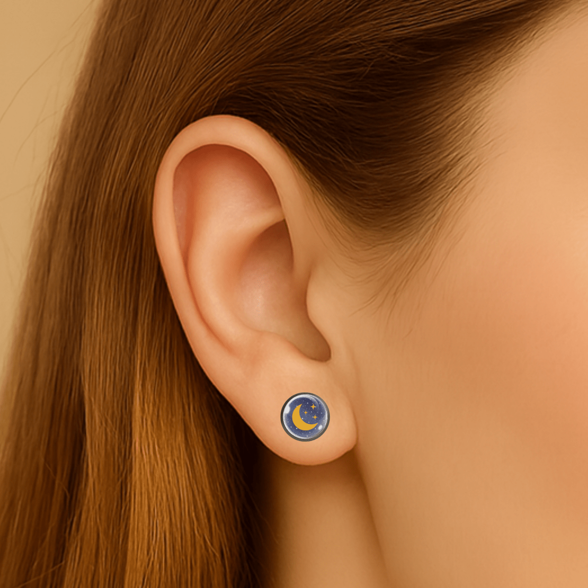 Close-up of an ear wearing a celestial-themed earring with a moon and star design.