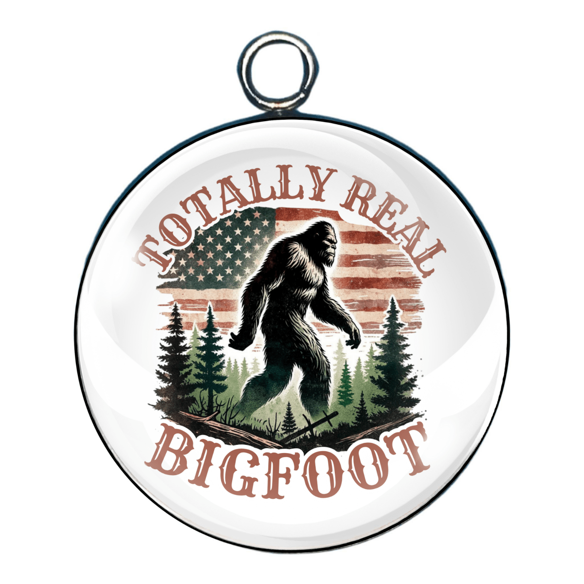 Charm that says “Totally Real Bigfoot,” with Bigfoot walking through the woods and an American flag faded in the background.