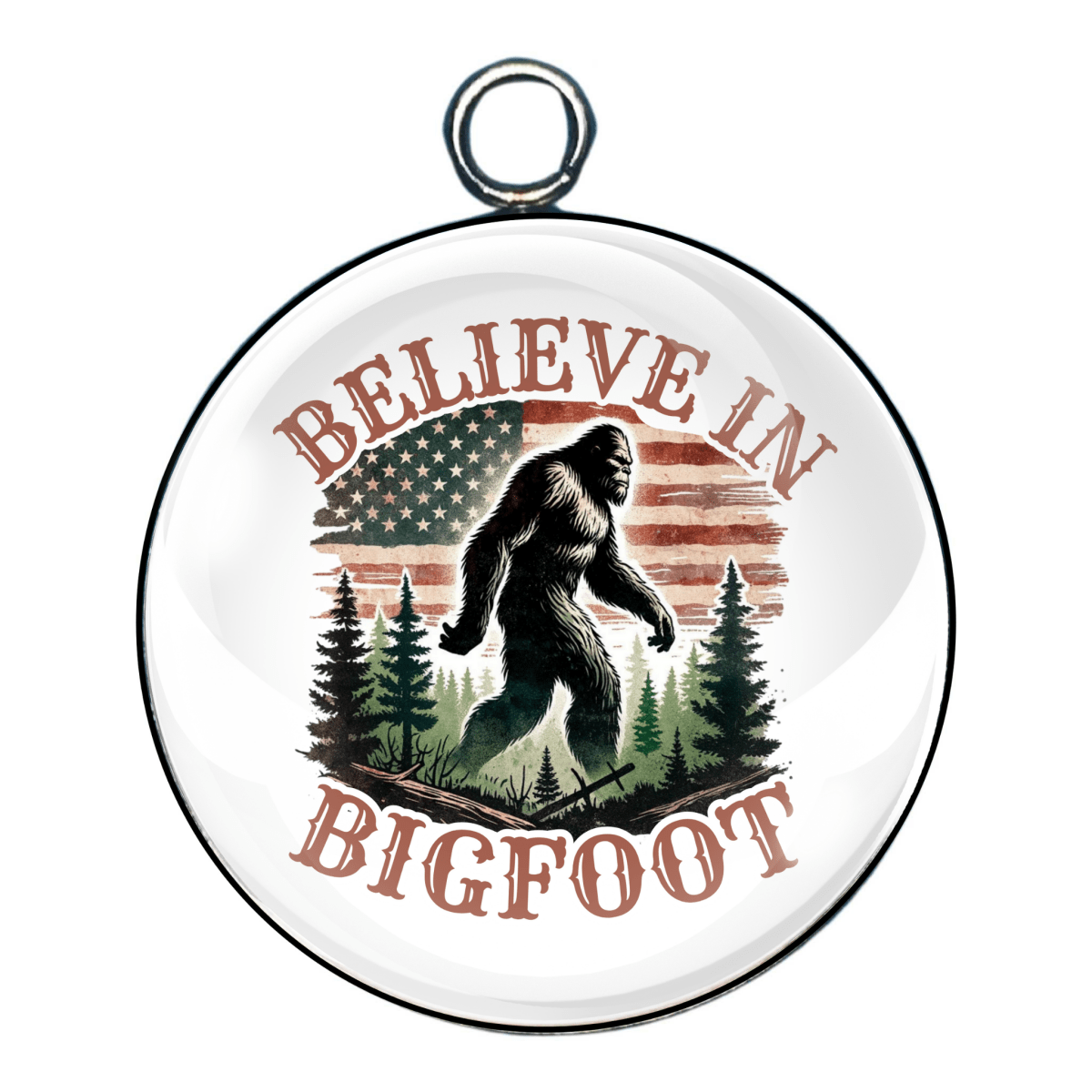 Charm with the phrase “Believe In Bigfoot,” featuring a Bigfoot figure among evergreen trees and a vintage-style flag.
