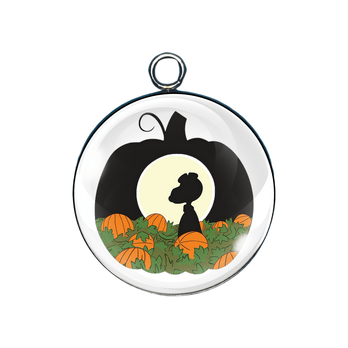 Circular pendant with a silhouette of a dog in a pumpkin patch design.
