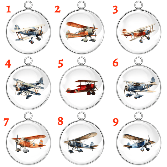Nine vintage biplane airplane glass cabochon charms in stainless steel settings with numbered styles, featuring retro aircraft in various colors and angles.