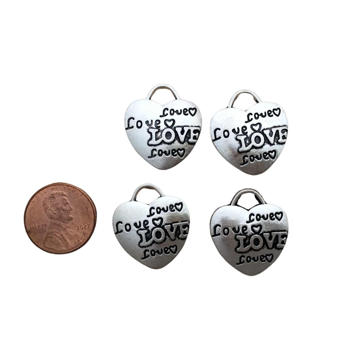 4 tibetan silver heart charms with the word"Love" 4 times with hearts on each charm