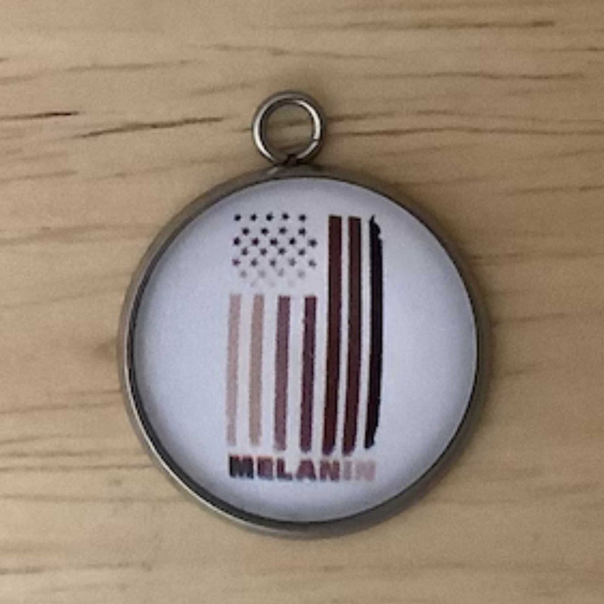 a multi shaded brown flag with the word ' melanin'