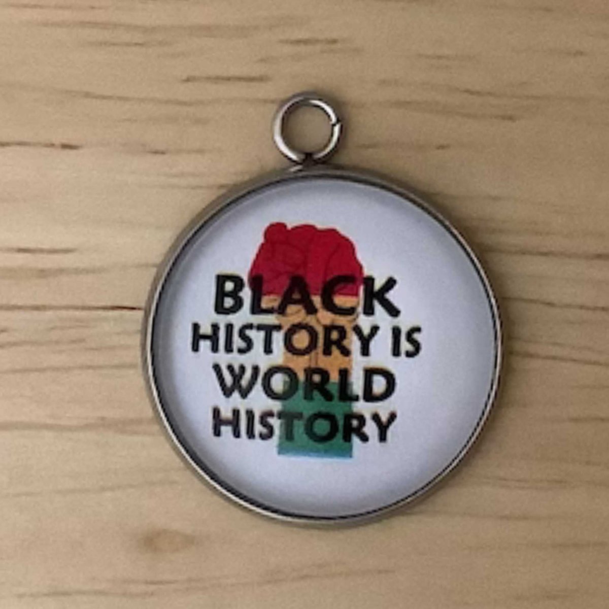 a red, yellow, green fist with the wording ' black history is world history'
