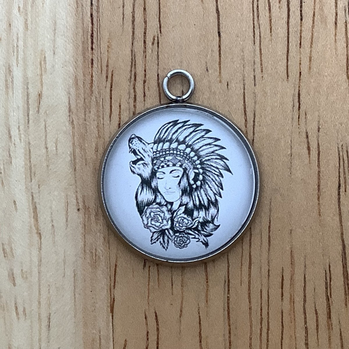 black and white graphic of a native woman in a headdress and a wolf head