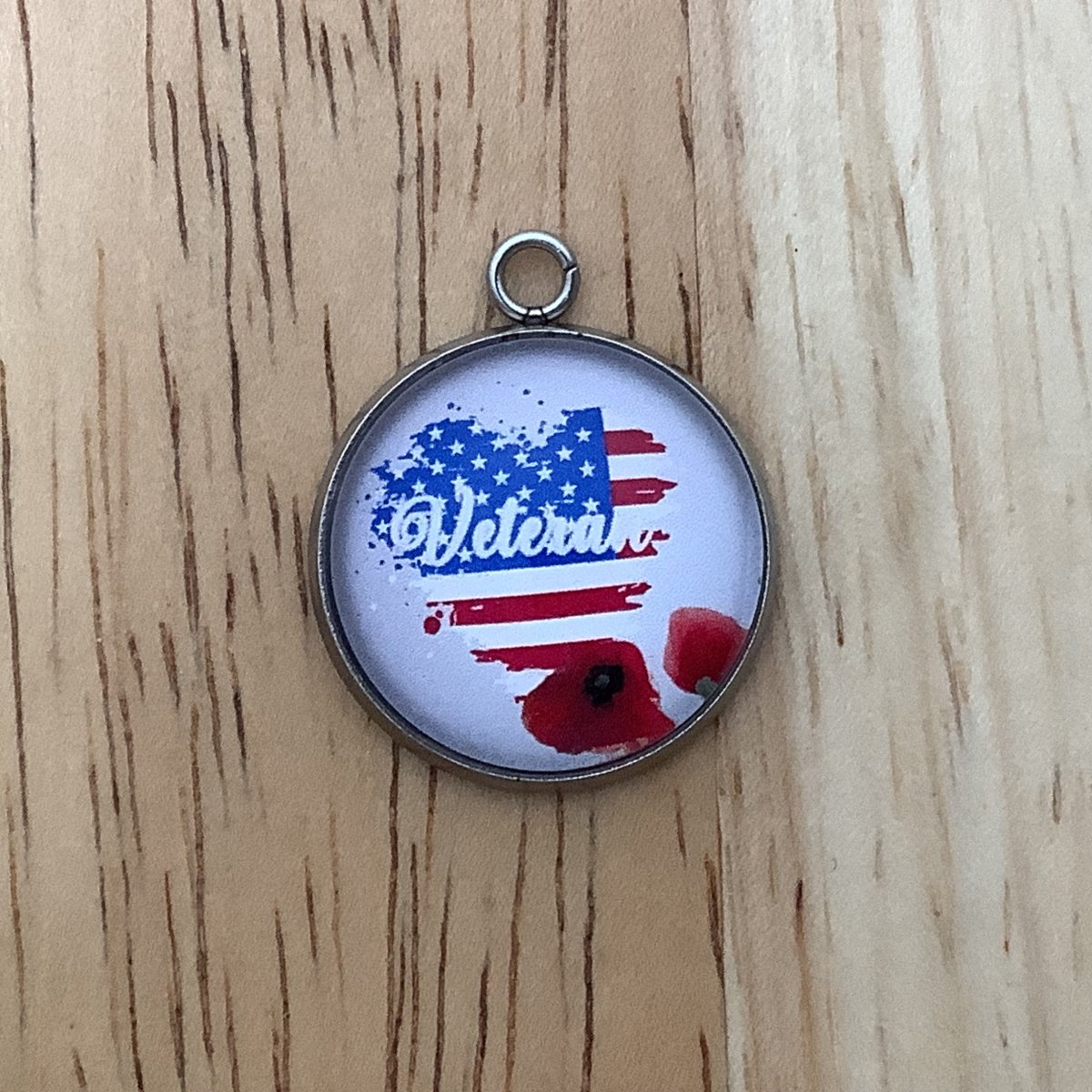charm featuring a United States Flag and poppies