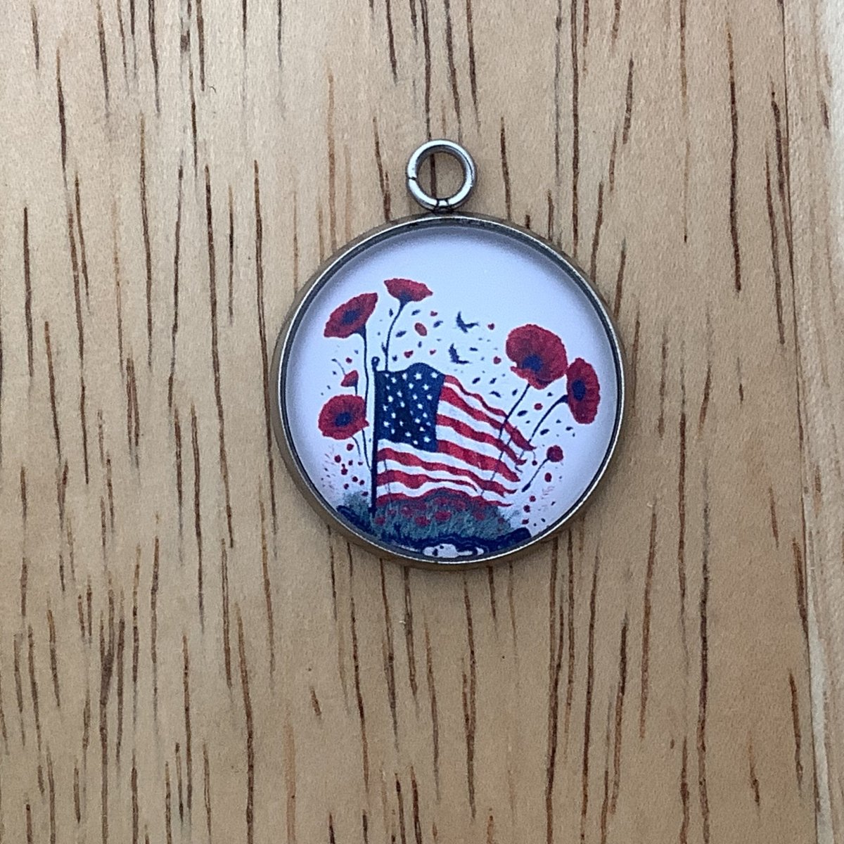 charm featuring a United States Flag and poppies