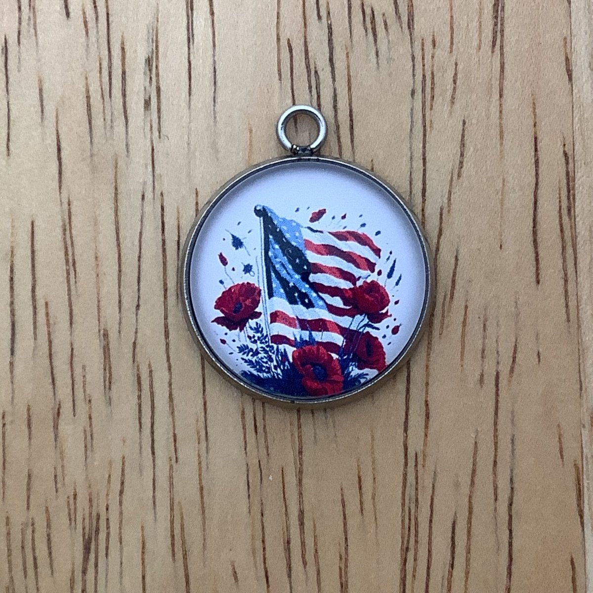 charm featuring a United States Flag and poppies