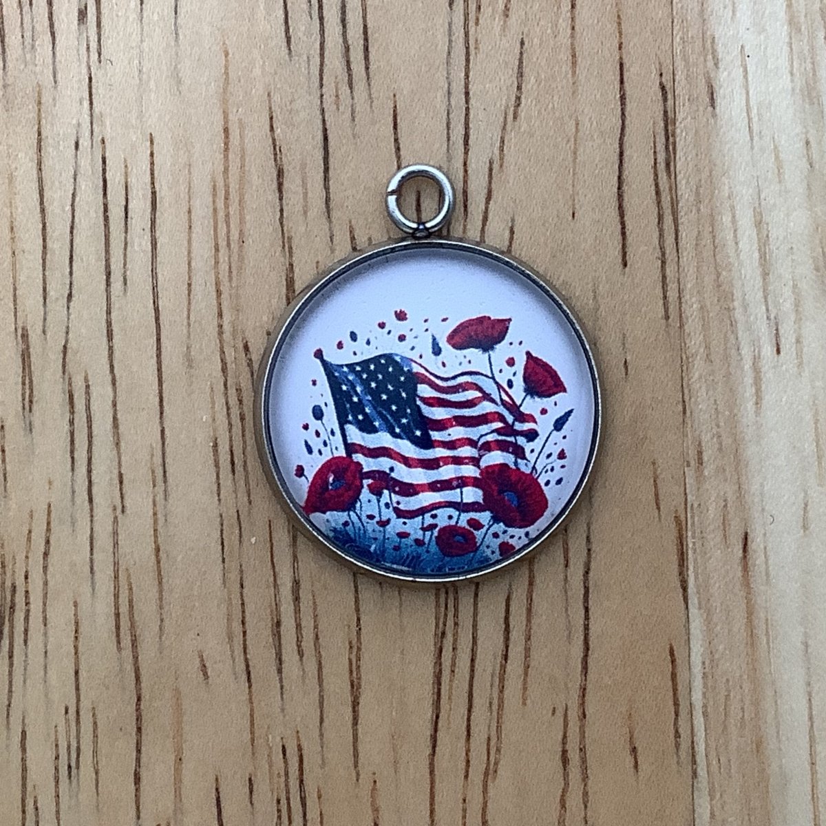 charm featuring a United States Flag and poppies