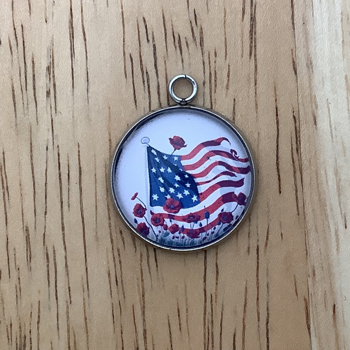 charm featuring a United States Flag and poppies