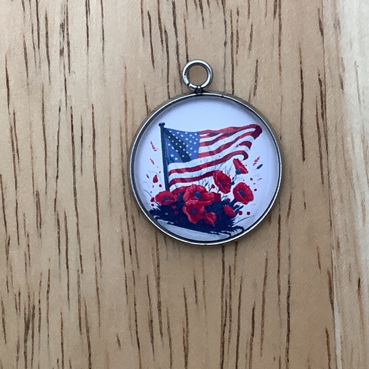 charm featuring a United States Flag and poppies