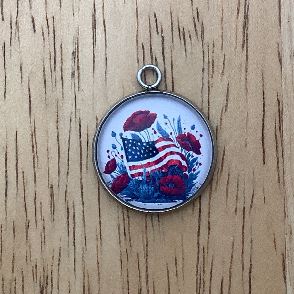 charm featuring a United States Flag and poppies