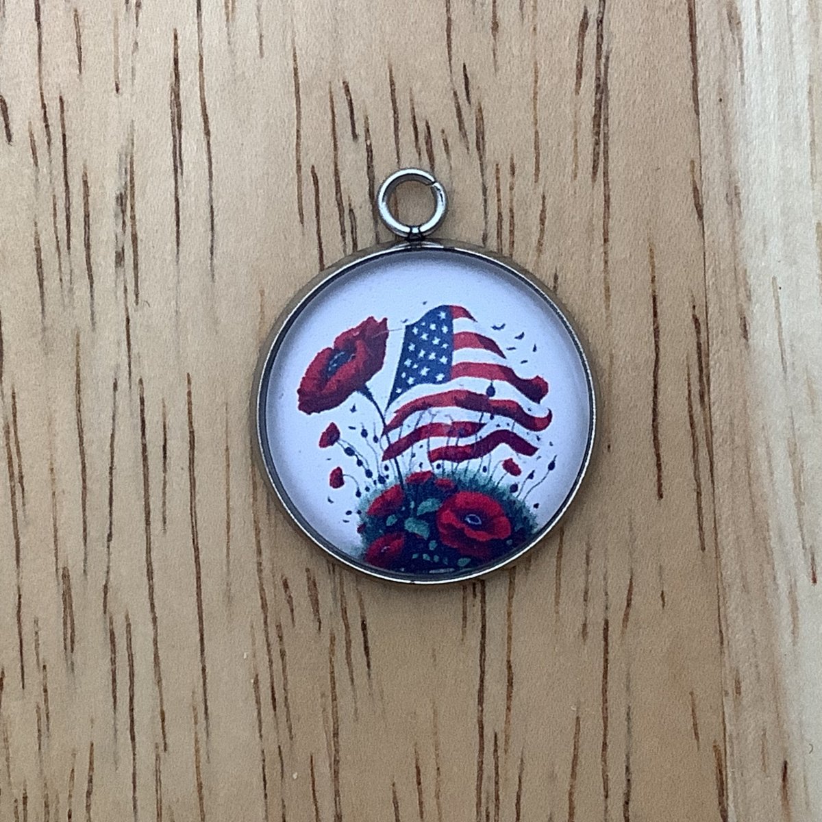 charm featuring a United States Flag and poppies