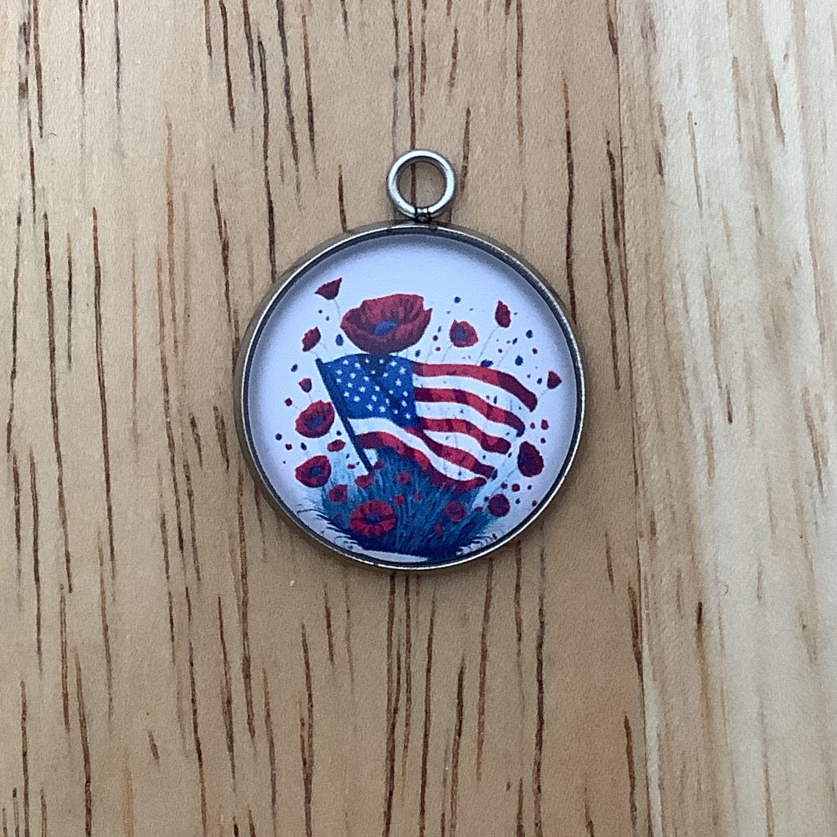 charm featuring a United States Flag and poppies