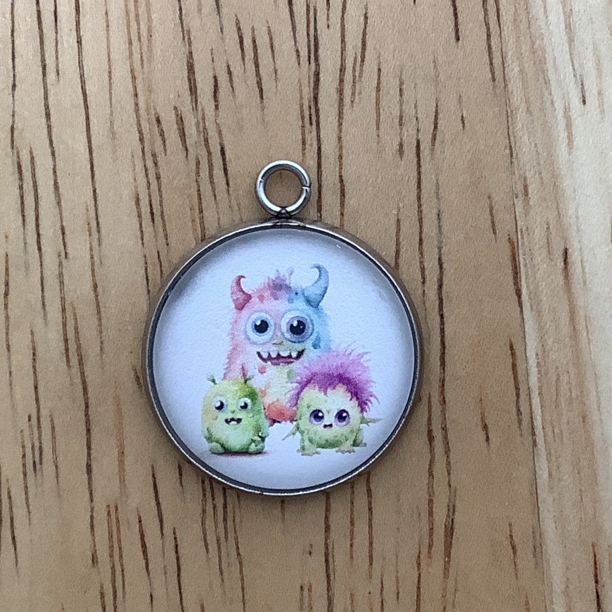 3 cute monsters, 2 green and one rainbow colored