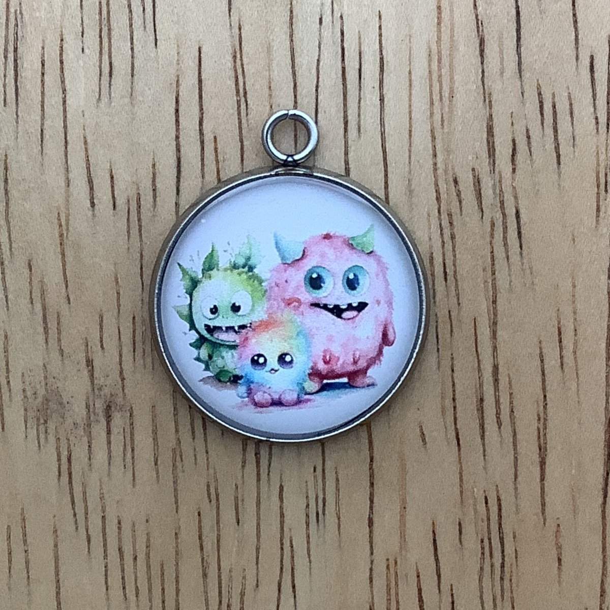 a group of 3 monsters. Pink, green and rainbow