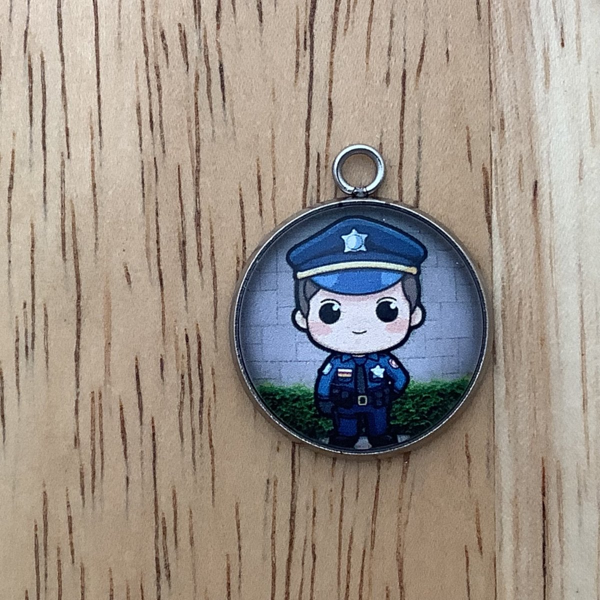 Charm featuring a policeman
