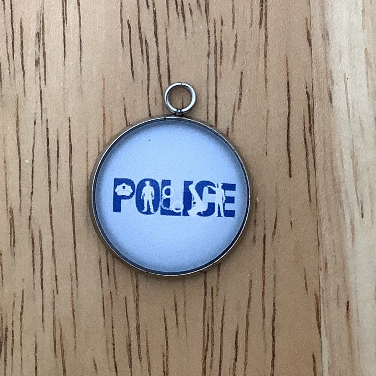 The word Police with a hat, a silhouette of an officer, hancuffs, and gun.