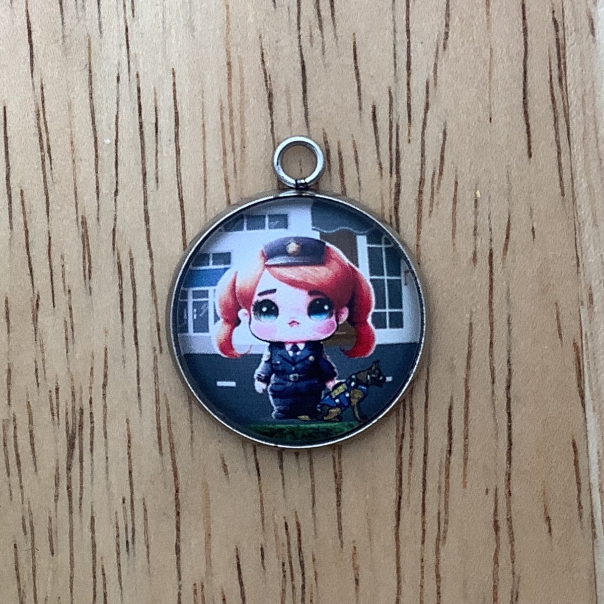 charm depicting a police officer with a police dog