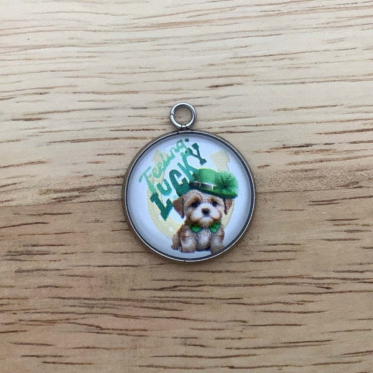 a puppy with a green hat and tie and the wording ' Feeling Lucky' with a  horseshoe in the background