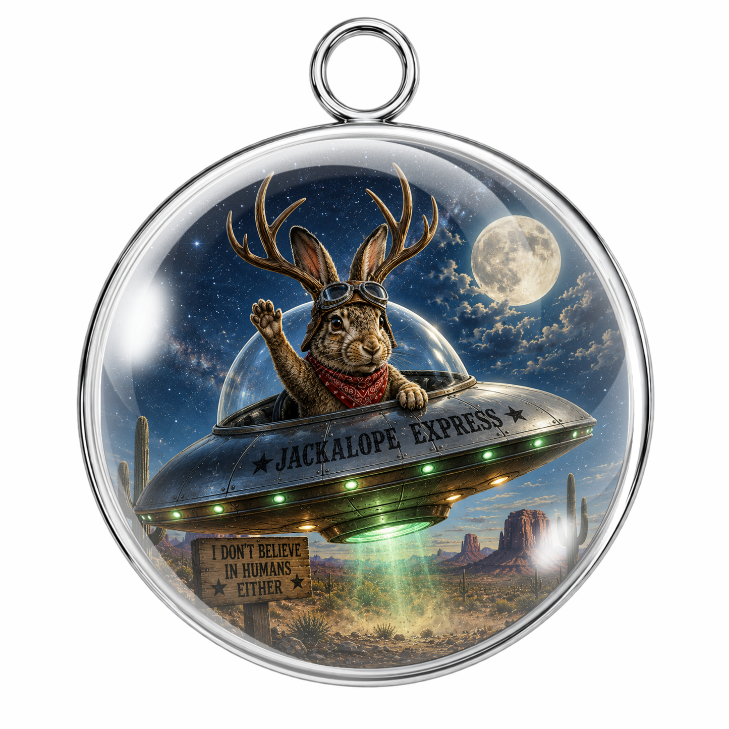 Round silver pendant with a detailed illustration of a rabbit wearing deer antlers and goggles, flying in a spaceship labeled 'JACKALOPE EXPRESS' over a desert landscape under a full moon.