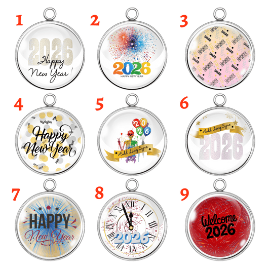 Set of nine handmade 2026 New Year charms with colorful fireworks, confetti, and festive lettering.