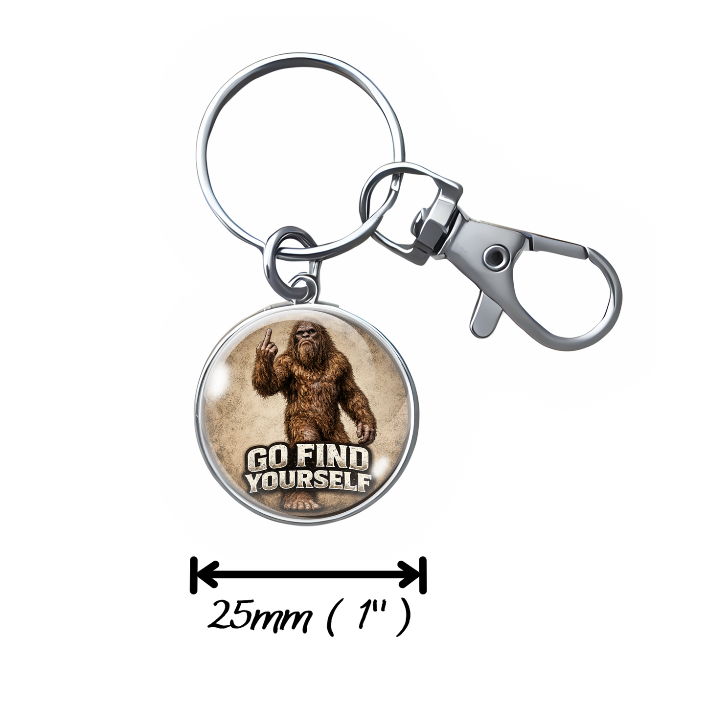 A silver metal keychain with a round charm featuring a Bigfoot-style figure and the text 'GO FIND YOURSELF.' A measurement arrow below the keychain indicates the diameter is 25mm (1 in).