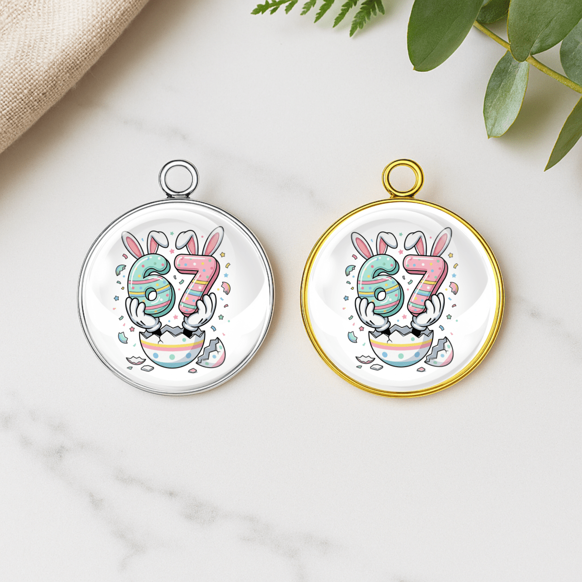Two circular pendants with colorful number design on a marble surface.