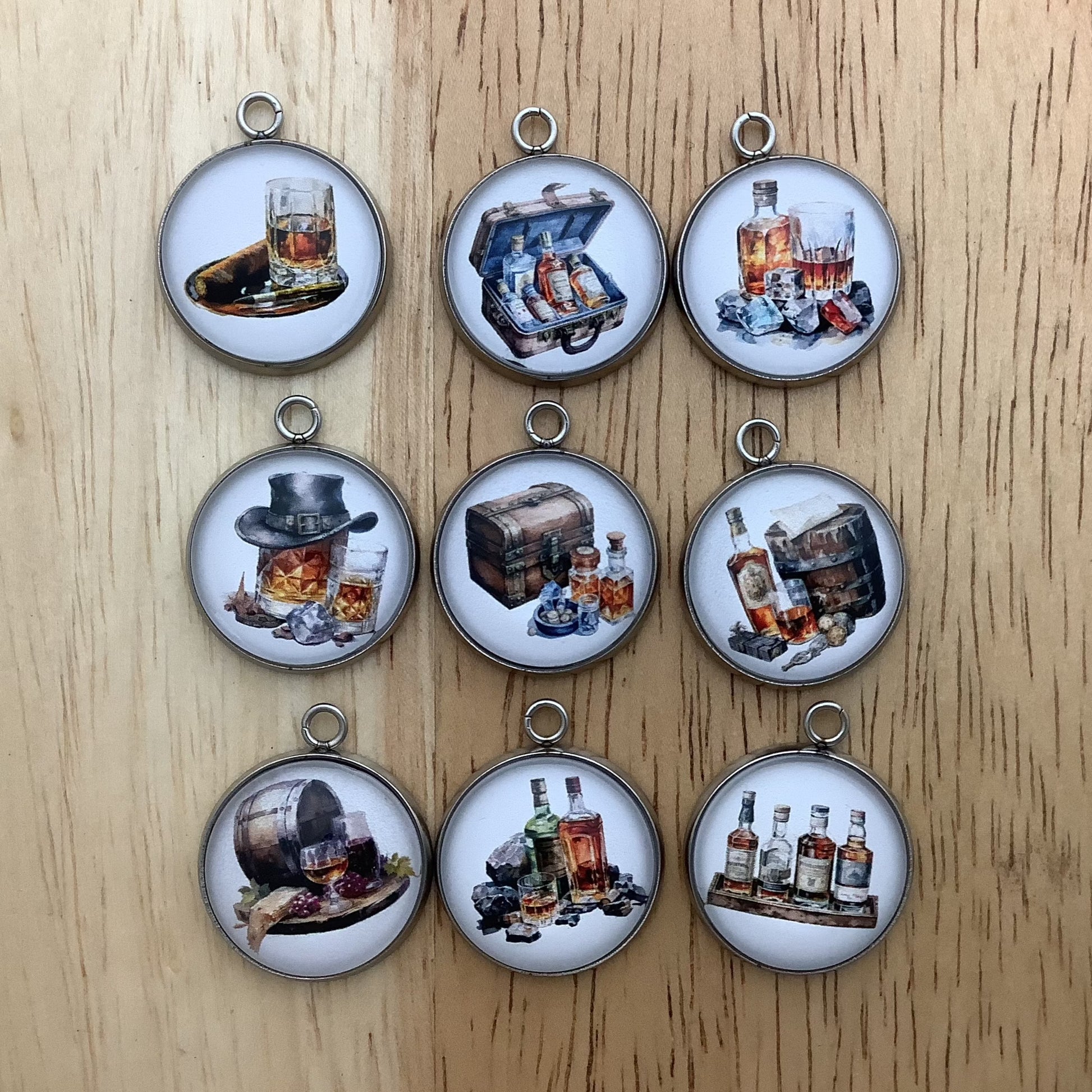 Group of 9 charms depicting bottles of alcohol