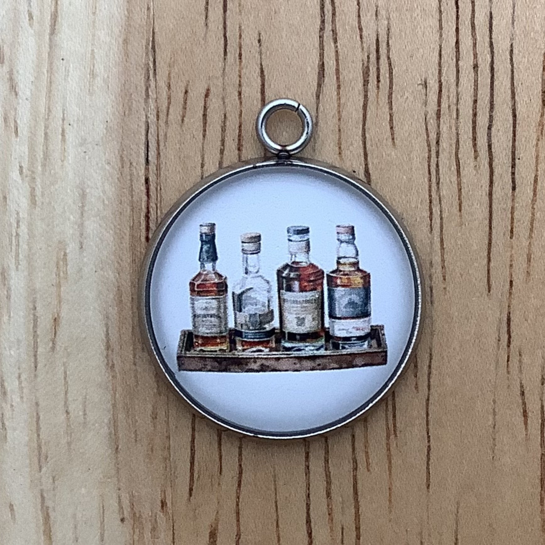 four bottles of liquor on a rectangular serving board.