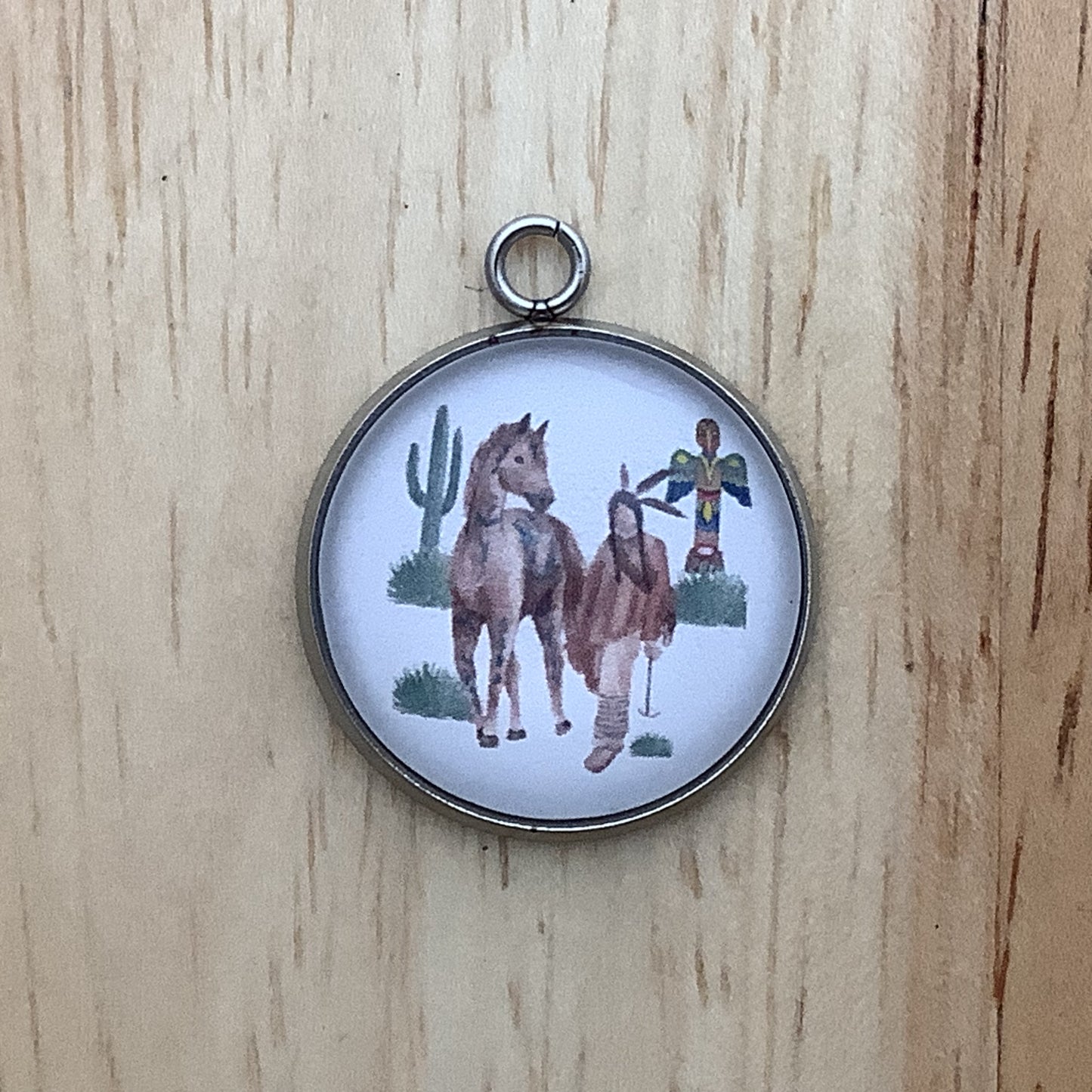 native walking with his horse with a cactus and a totem pole in the background