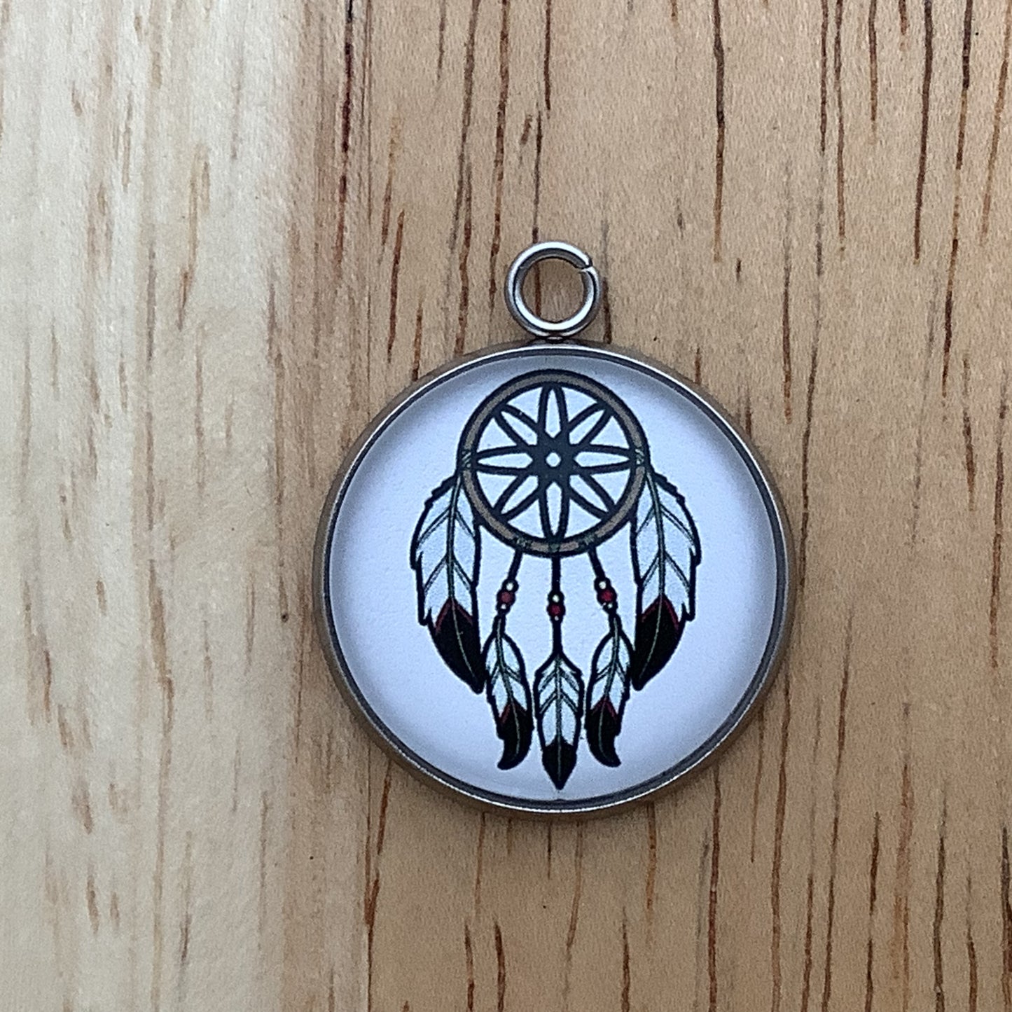 black and white dream catcher with 5 hanging feathers