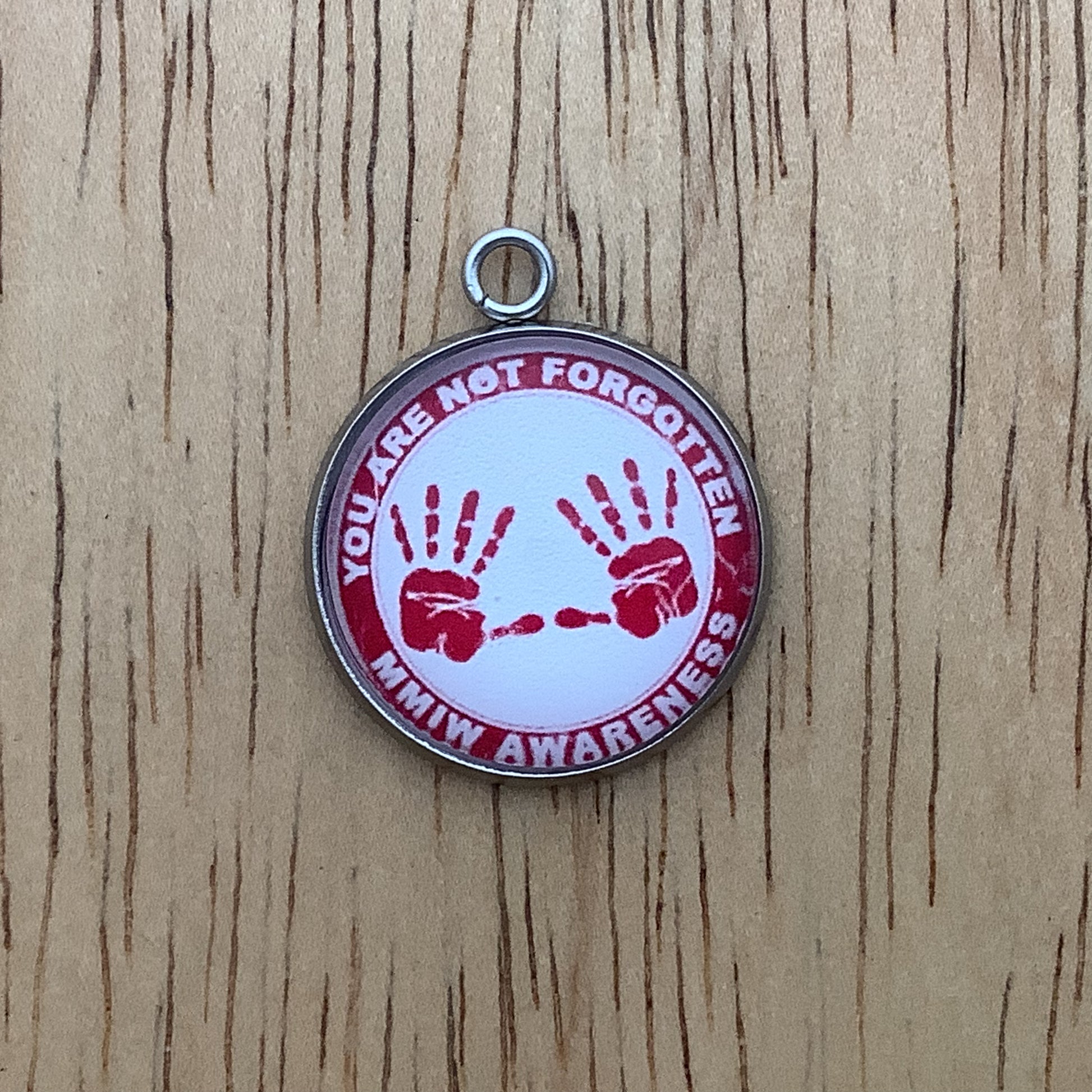 two red handprints with the words "you are not forgotten, MMIW awareness" written around it