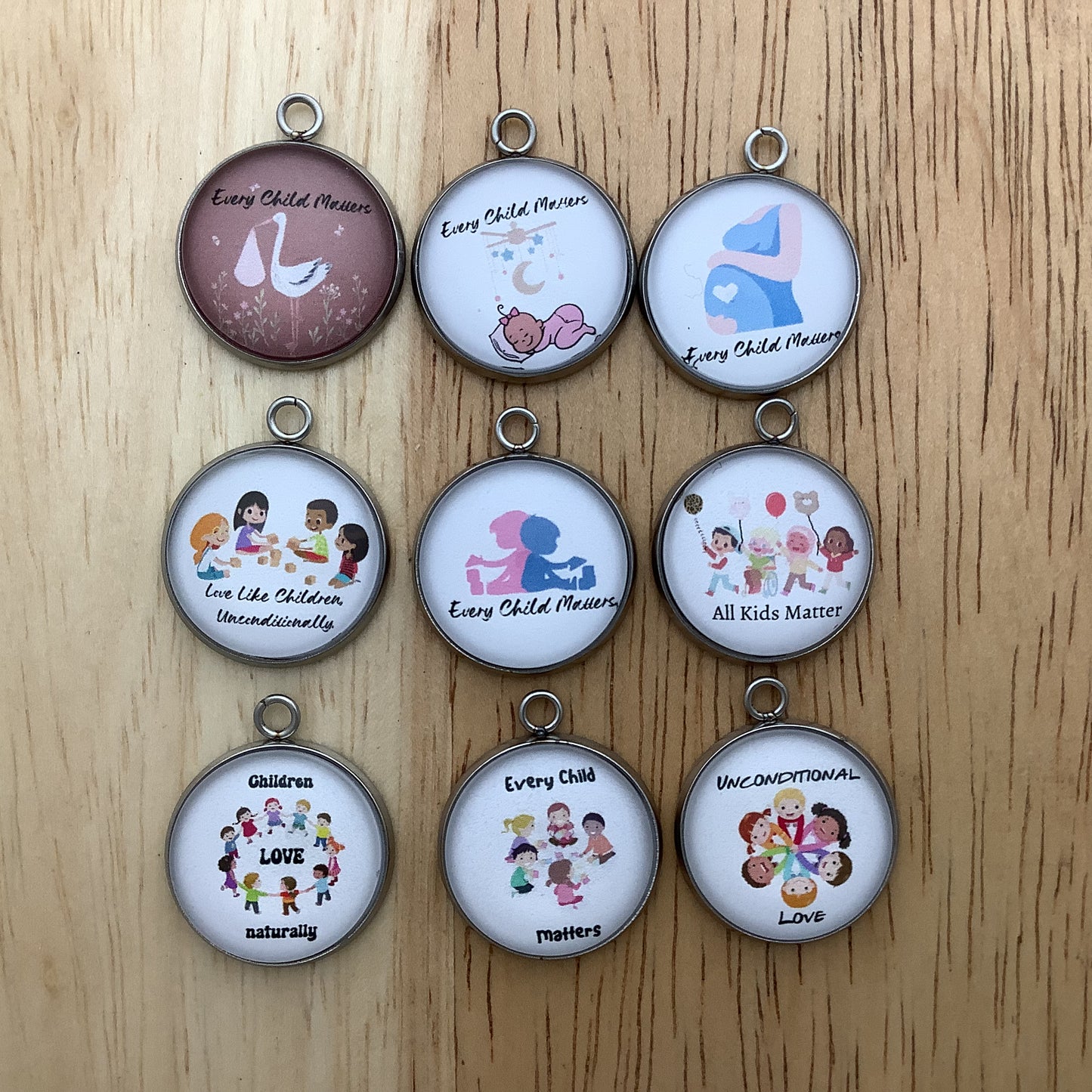 Group of 9 charms depicting that all children matter