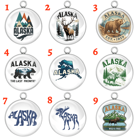 Nine circular pendants featuring various Alaska-themed designs on a white background.