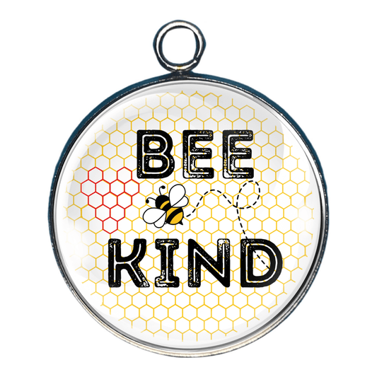 Handmade Bee Kind glass cabochon charm with bee, honeycomb background, and hidden honeycomb heart.