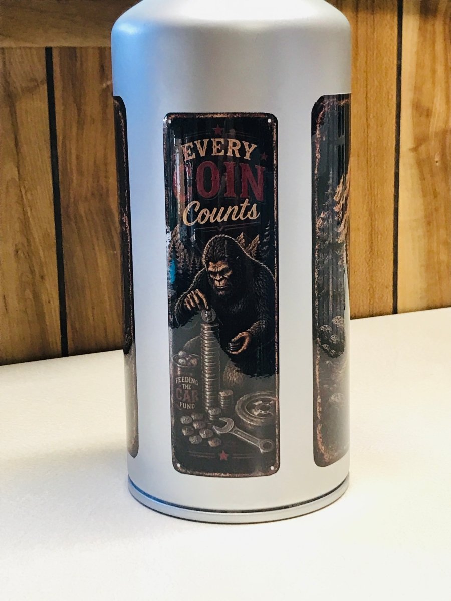 A white cylindrical coin jar with three vertical panels, featuring a central dark panel with an illustration of a giant ape and the text 'EVERY COIN Counts'.