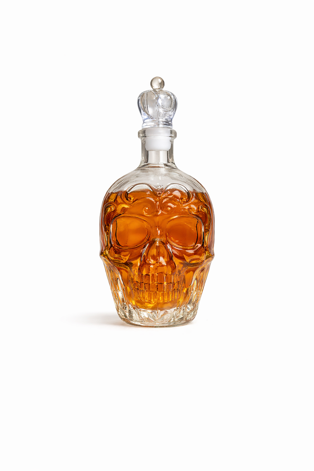 Skull-shaped decanter with amber liquid on a white background