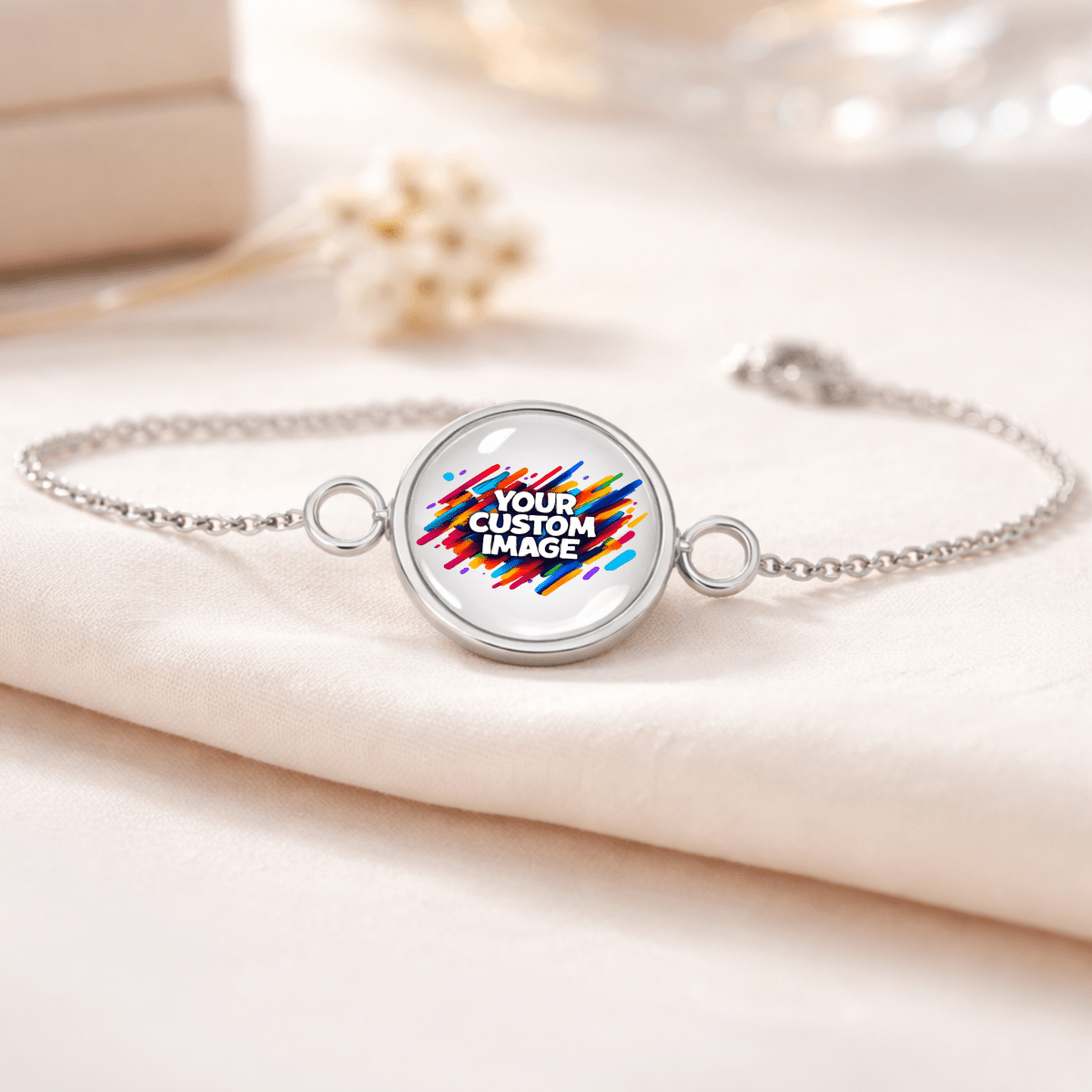 Silver bracelet with a round charm displaying 'Your Custom Image' on a light fabric background