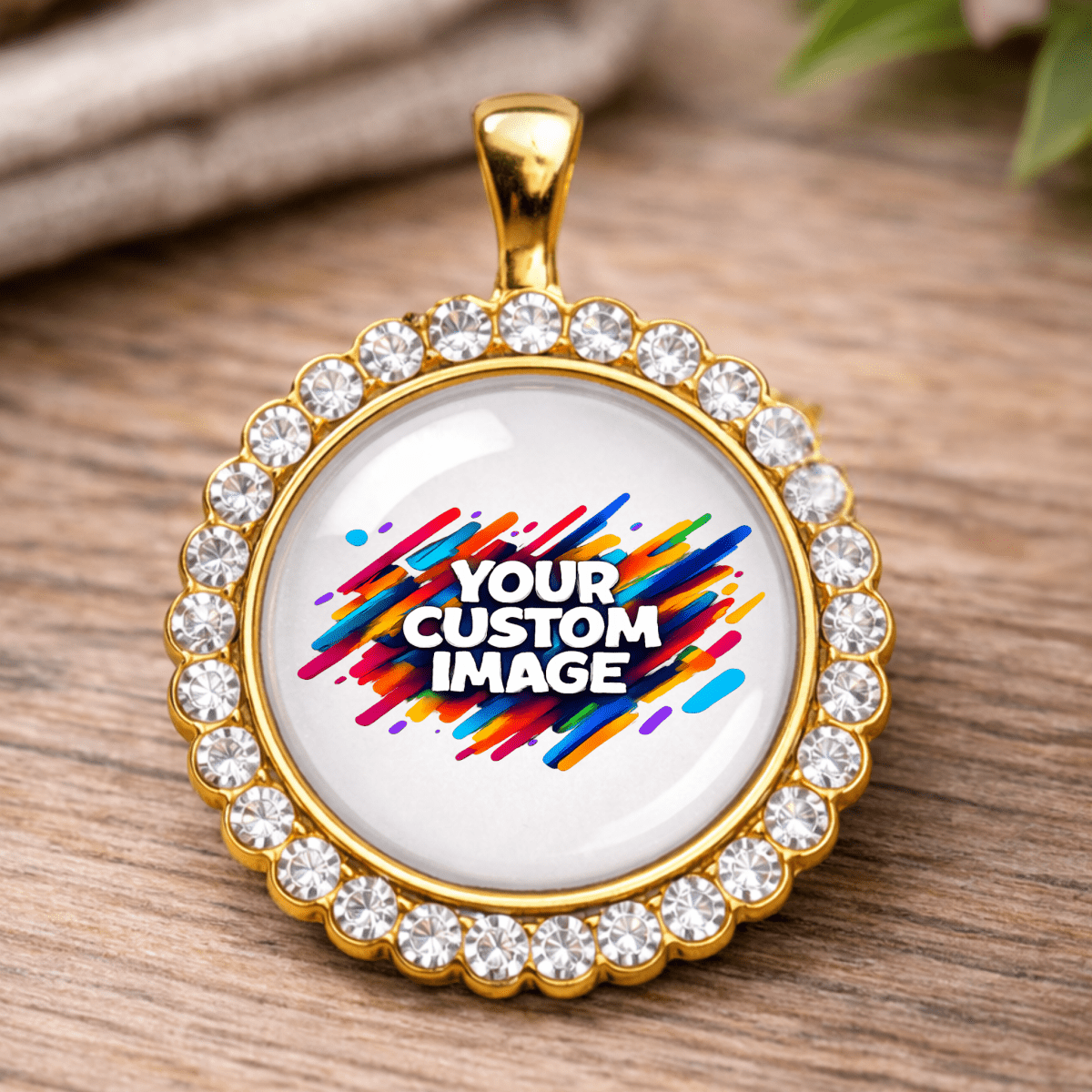 Gold-framed pendant with customizable image text on a wooden surface