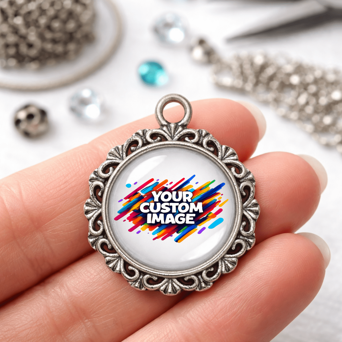 Jewelry pendant with 'Your Custom Image' text held in a hand