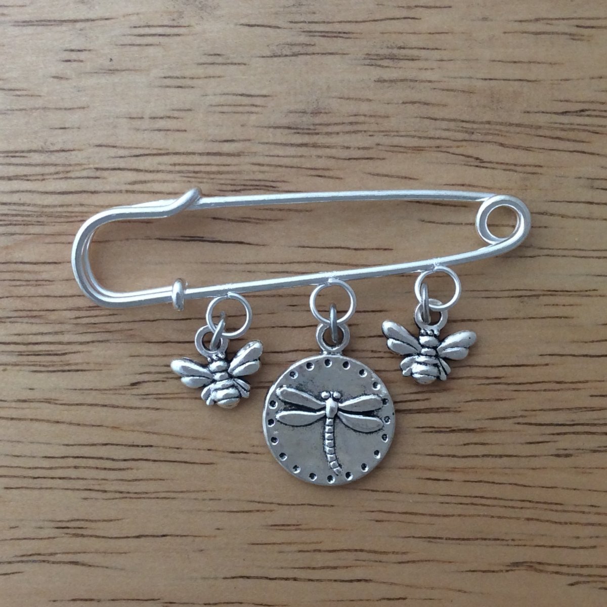 stainless steel lapel pin with 2 honey bee dangle charms and 1 dragonfly dangle charm