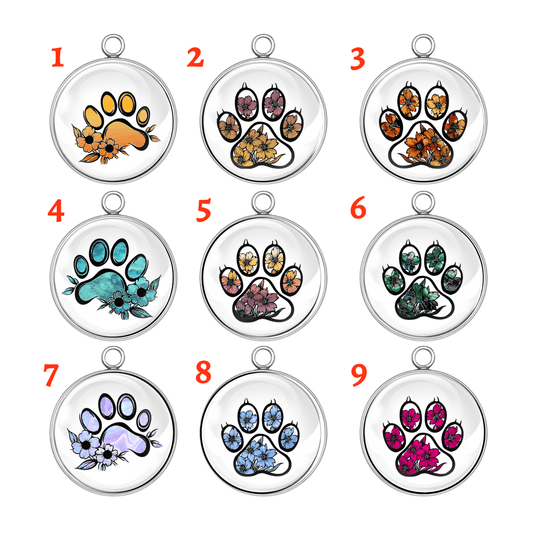 Nine paw print-shaped pendants with various designs on a white background