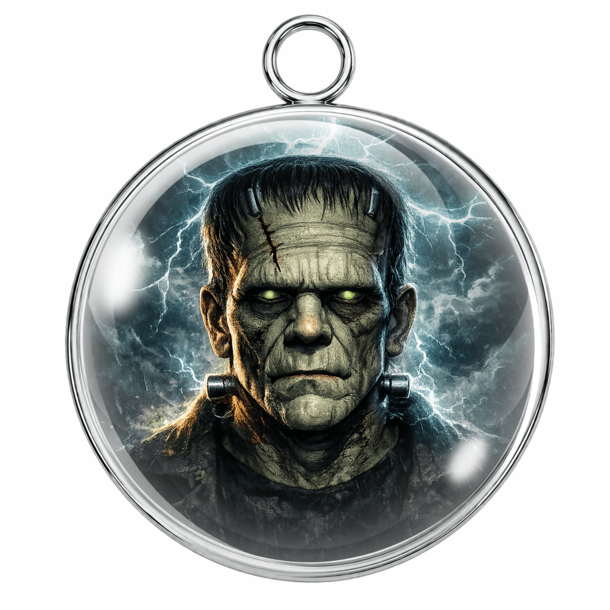 A round pendant featuring a detailed illustration of the character Frankenstein with green glowing eyes and lightning in the background, enclosed in a silver-toned metal frame with a hanging loop at the top.