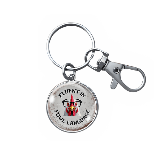 Keychain with a round pendant featuring text and a graphic of a person with glasses on a white background